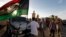 Libyan security forces evict an armed group from a compound in Tripoli, Sept. 23, 2012.