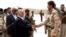 Iraqi Prime Minister Haidar al-Abadi, left, who was touring Anbar province, visiting army units, shakes hands with a Sunni tribesman at Camp Habbaniyah, in the eastern city of Ramadi, Iraq, April 8, 2015. 