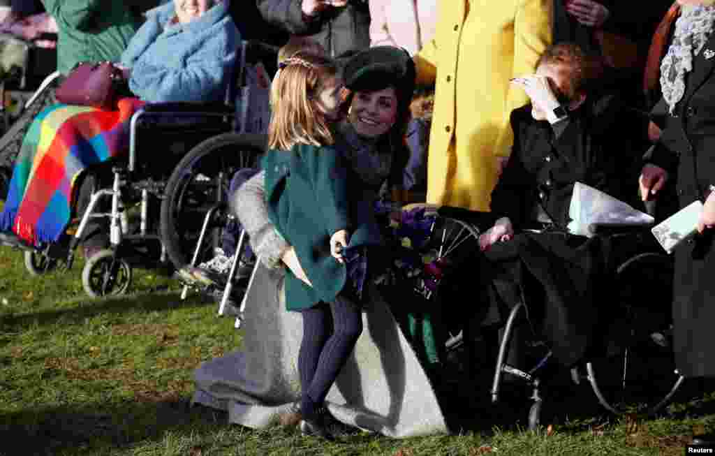 Catherine, Duchess of Cambridge, and Princess Charlotte greet people as they leave the St. Mary Magdalene&#39;s church after the Royal Family&#39;s Christmas Day service on the Sandringham estate in England.