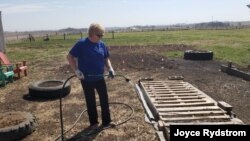 Joyce Rydstrom of Alta, Iowa, had to shut the doors to her hair salon in March last year amid the coronavirus pandemic. These days, she spend some of her free time gardening.