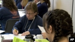 Inmates Lisa Bode (left) and Cynthia Thompson participate in the LIFE (Lifelong Information For Entrepreneurs) program at the Coffee Creek Correctional Facility in Oregon.