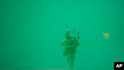 Lance Corporal Jamie Killorn of the 4 SCOTS The Highlanders Company plays the pipe at the end of the Steadfast Dart 2025 exercise, involving some 10,000 troops from nine nations and representing the largest NATO operation planned this year, at a training range in Smardan, eastern Romania.