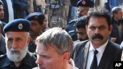 Pakistani police escort arrested US national, identified as Raymond Davis (C), to a court in Lahore on January 28, 2011