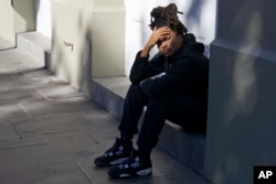 Trevant Hayes, 20, sits in the French Quarter after the death of his friend, Nikyra Dedeaux, 18, after a pickup truck crashed into pedestrians on Bourbon Street followed by a shooting in the French Quarter in New Orleans, Jan. 1, 2025.