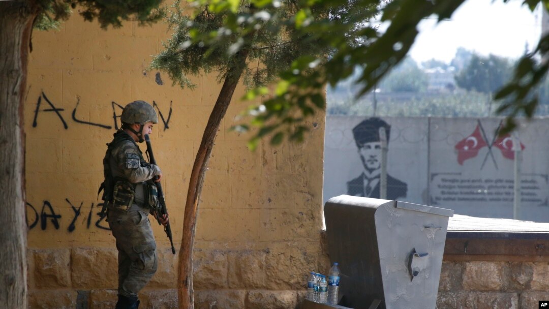 A Turkish soldier stands at the border with Syria in Akcakale, Sanliurfa province, southeastern Turkey, Thursday, Oct. 10, 2019. (AP Photo/Lefteris Pitarakis)