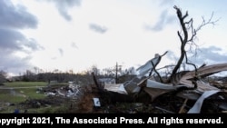 The sun rises over weather-damaged properties at the intersection of County Road 24 and 37 in Clanton, Ala., following a large outbreak of severe storms across the southeast, March 18, 2021.