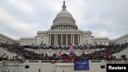 FILE - A mob of supporters of U.S. President Donald Trump storm the U.S. Capitol Building in Washington, U.S., Jan. 6, 2021. 