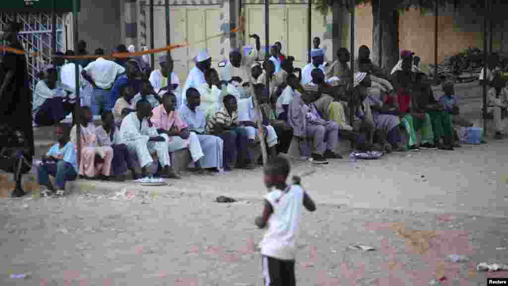 People watch as youths play a game of Eton fives in a court in Katsina.