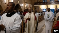Archbishop of Kinshasa Fridolin Ambongo Besungu (C) arrives for a Christmas Mass at our Lady of the Congo Cathedral in Kinshasa on December 24, 2023. (Photo by Patrick Meinhardt / AFP)