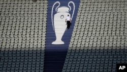 FILE - A security official walks past a Champions League trophy logo during an Inter Milan training session at the Ataturk Olympic Stadium in Istanbul, Turkey, June 9, 2023.