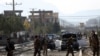 FILE - Afghan security personnel gather at the site of car bomb in Kabul, Afghanistan, Nov. 13, 2019. A car bomb detonated in the Afghan capital of Kabul during the morning commute, killing several people, officials said. 