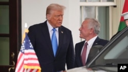 U.S. President Donald Trump greets Jordan's King Abdullah II at the White House on Feb. 11, 2025, in Washington.