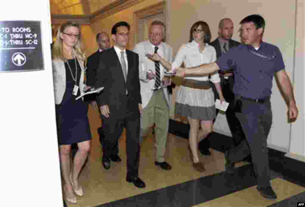 House Majority Leader Eric Cantor of Va., is followed by reporters as walks out of a caucus meeting on Capitol Hill in Washington, Friday, July 29, 2011. (AP Photo/Susan Walsh)