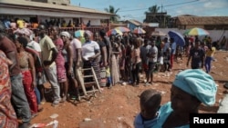 FILE - People wait to cast their votes during Liberia's presidential election in Monrovia, Liberia October 10, 2023.