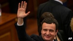 FILE - Albin Kurti, newly elected prime minister of Kosovo, waves after a new government was elected in Pristina, Feb. 3, 2020.