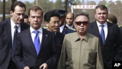 North Korean leader Kim Jong Il, second right, and Russian President Dmitry Medvedev, second left, walk during a meeting an a military garrison, outside Ulan-Ude, Wednesday, Aug. 24, 2011. Russian Defense Minister Anatoly Serdyukov is at right.