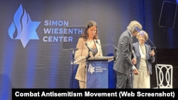 FILE - A survivor of Hamas' Oct. 7, 2023 terror attack, Natalie Sanandaji, left, accepts the Simon Wiesenthal Center's Medal of Valor and another award in New York, Sept. 12, 2024. She participated in a video made to demonstrate solidarity with Iranian women resisting oppression.