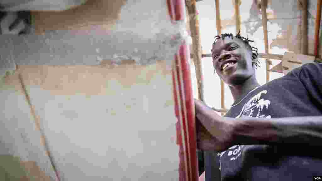 Pape Diouf shapes a surfboard in his Dakar workshop. (Annika Hammerschlag/VOA)