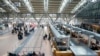 Passengers stand in front of counters at Hamburg Airport, Germany, March 9, 2025. (Georg Wendt/dpa via AP)