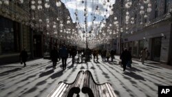 FILE - People walk along Nikolskaya Street near the Kremlin on a sunny day in Moscow, Russia, March 9, 2019. 