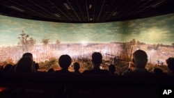 FILE - Visitors view the Atlanta Cyclorama, the colossal Civil War painting in Atlanta, June 30, 2015. 