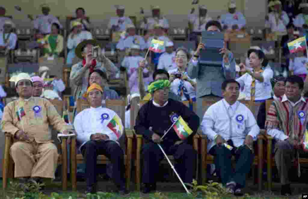 Myanmar lawmakers in different ethnic attire, watch and take pictuMyanmar army officers command as they participate in a ceremony to mark Myanmar's 67th anniversary of Independence Day in Naypyitaw, Myanmar, Sunday, Jan. 4, 2015. (AP Photo/Gemunu Amarasin