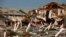 FILE - An American flag flies amongst rubble left in the aftermath of Hurricane Michael in Mexico Beach, Florida, Oct. 11, 2018.