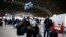 Passengers wait in front of the desk of Air France at the Roissy Charles de Gaulle airport, north of Paris, March 12, 2020.