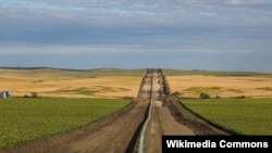 FILE - The Dakota Access Pipeline, installed between farms, as seen in New Salem, North Dakota, Aug. 25, 2016.