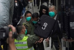 Democracy advocate Jimmy Lai, right, arrives at Hong Kong's Court of Final Appeal, Feb. 9, 2021.