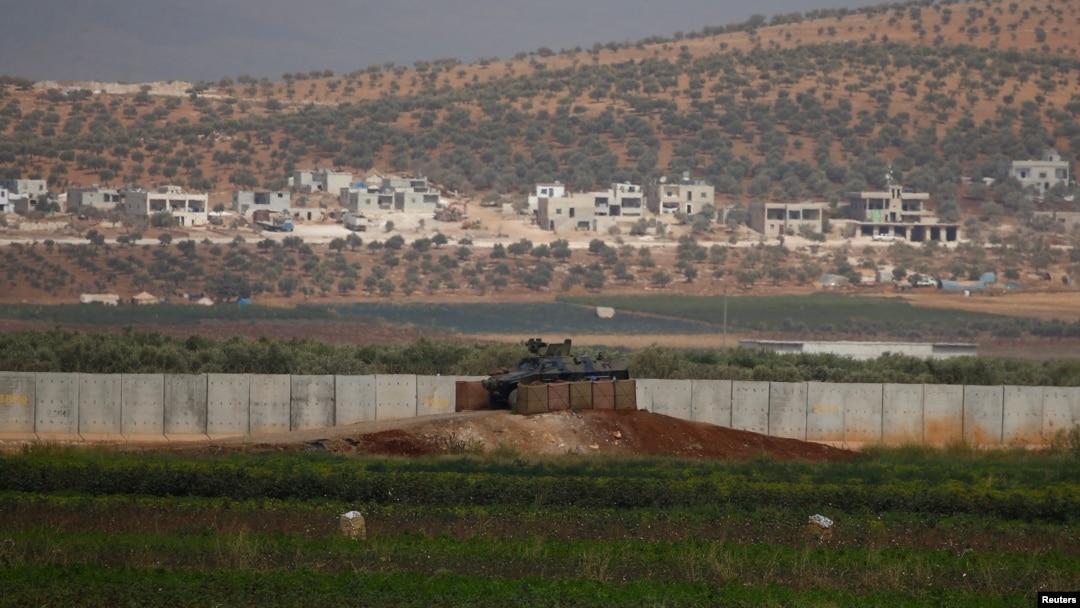 A Turkish military armoured vehicle guards on the border line located opposite the Syrian Atimah, Idlib province in Reyhanli, Hatay province, Turkey, Oct. 8, 2017.