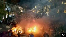 FILE - Protesters pour into the streets outside the parliament building in Tbilisi, Georgia, Nov. 29, 2024. 