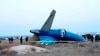 FILE - In this photo taken from a video released by the administration of Mangystau region, a part of Azerbaijan Airlines' Embraer 190 lies on the ground near the airport of Aktau, Kazakhstan, Dec. 26, 2024.