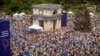 People holding European Union and Moldovan flags fill the Great National Assembly Square in Chisinau, Moldova, Sunday, May 21, 2023, at the end of a rally called by President Maia Sandu, aiming to show the country's support for EU membership. (AP Photo/Aurel Obreja)