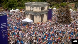 People holding European Union and Moldovan flags fill the Great National Assembly Square in Chisinau, Moldova, May 21, 2023.