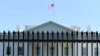 U.S. Secret Service officers stand guard as construction crews work on renovations to the perimeter fence on the North Lawn of the White House, February 27, 2020. (Saqib Ul Islam/VOA)