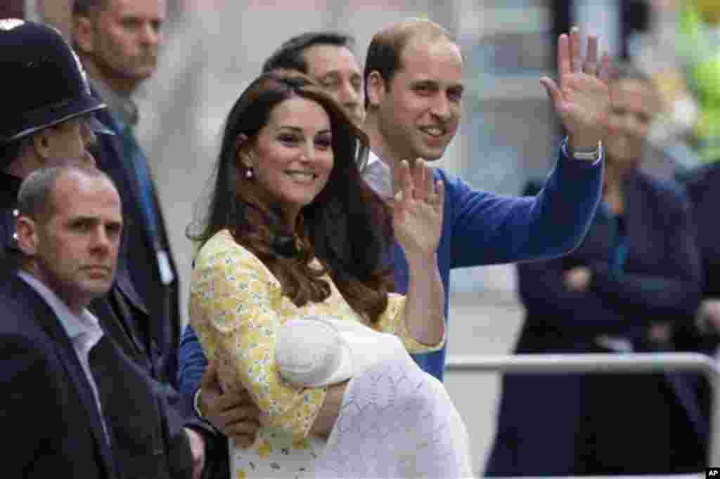 Britain's Prince William and Kate, Duchess of Cambridge and their newborn baby princess, wave to the public as they leave St. Mary's Hospital's exclusive Lindo Wing in London, Saturday, May 2, 2015. (AP Photo/Tim Ireland)