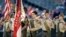 FILE - A color guard of Boy Scouts from the Chief Seattle Council salute during the national anthem before a baseball game between the Seattle Mariners and Houston Astros in Seattle, May 25, 2014.