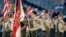 A color guard of Boy Scouts from the Chief Seattle Council salute during the national anthem before a baseball game between the Seattle Mariners and Houston Astros in Seattle, May 25, 2014.
