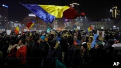 A protester waving a Romanian flag during a protest in Bucharest, Romania, Feb. 2, 2017. 