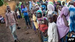 FILE - Refugees from Central Africa wait in Cameroonianian Garoua Boulaï border town for foods and clothes delivering by humanitarian associations. 