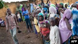 FILE - Refugees from Central Africa wait in Cameroonianian Garoua Boulaï border town for foods and clothes delivering by humanitarian associations. 