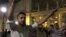 A Syrian man organizes a sit-in outside Budapest's East railway station Friday night as thousands of stranded migrants await passage to Austria, and ultimately Germany, Sept. 4, 2014 (VOA / L. Ramirez).