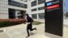 A runner passes the Ronald Reagan UCLA Medical Center on the campus of the University of California, Los Angeles Friday, April 26, 2019. Some students and employees possibly exposed to measles at two Los Angeles universities were still quarantined on campus or told to stay home F