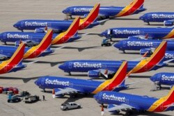 FILE - A number of grounded Southwest Airlines Boeing 737 Max 8 aircraft are shown parked at Victorville Airport in Victorville, California, March 26, 2019.