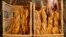 FILE - A French baker places freshly-baked baguettes, the traditional French bread, in wicker baskets in his shop in Strasbourg, eastern France, Aug. 6, 2010. 