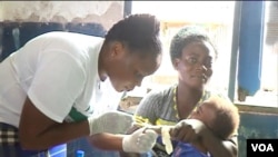 A nurse examines a baby in Idabato, Cameroon, Nov. 28, 2019. (Moki Edwin Kindzeka/VOA)