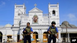 FILE - Sri Lankan Navy soldiers stand guard in front of the St. Anthony's Shrine a day after the series of blasts, in Colombo, Sri Lanka, Apr. 22, 2019.