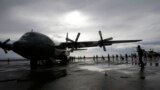 Typhoon survivors board a Philippine Air Force transport plane in Tacloban, Nov. 21, 2013.