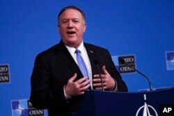 FILE - U.S. Secretary of State Mike Pompeo talks to journalists at the NATO headquarters in Brussels, Nov. 20, 2019.